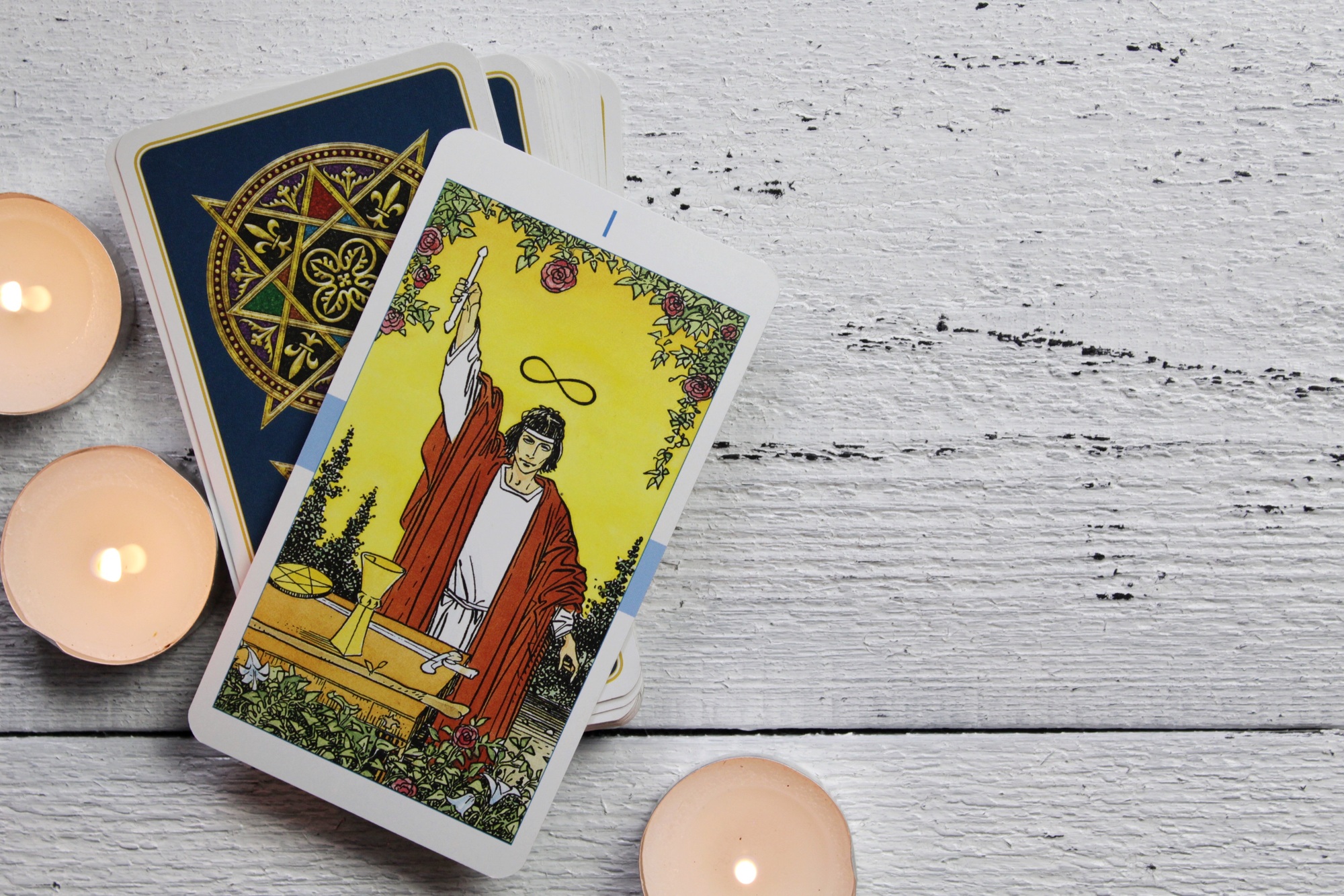 Tarot cards and candles on a wooden table