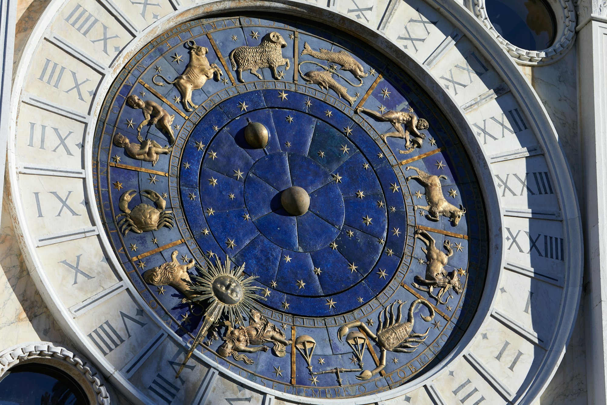 Golden zodiac astrological clock, sunlight and shadow