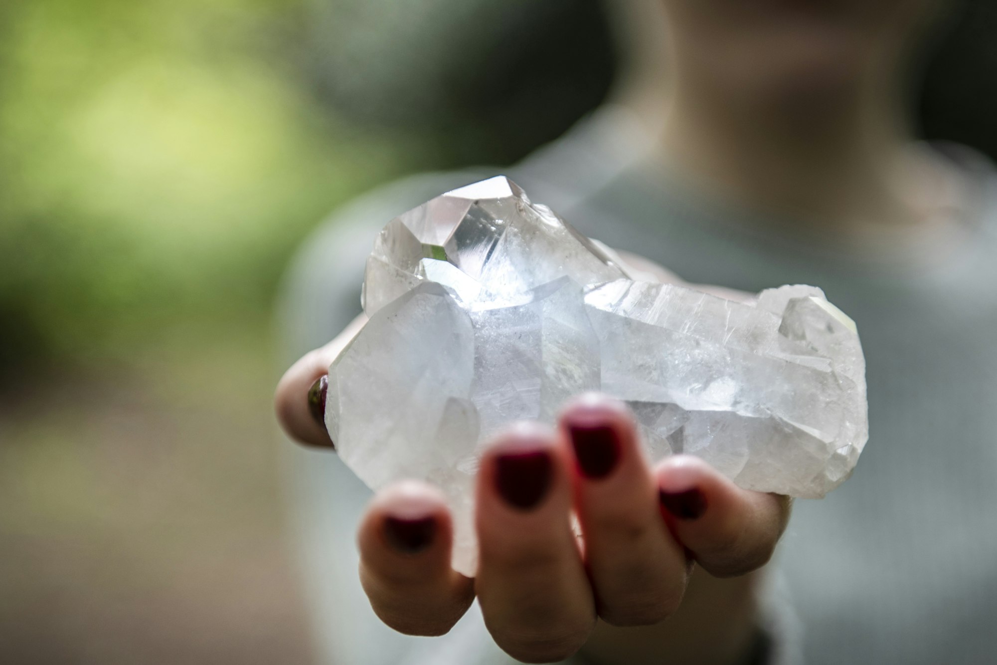 Woman holding healing crystal for Reiki